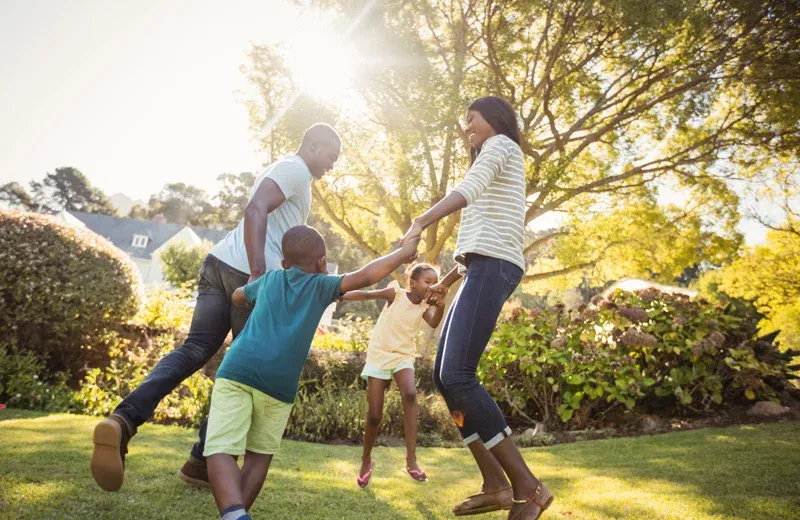 family playing outside tick and mosquito free yard